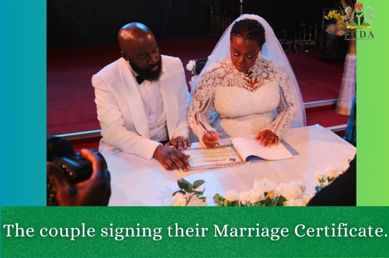 The couple signing their marriage certificate